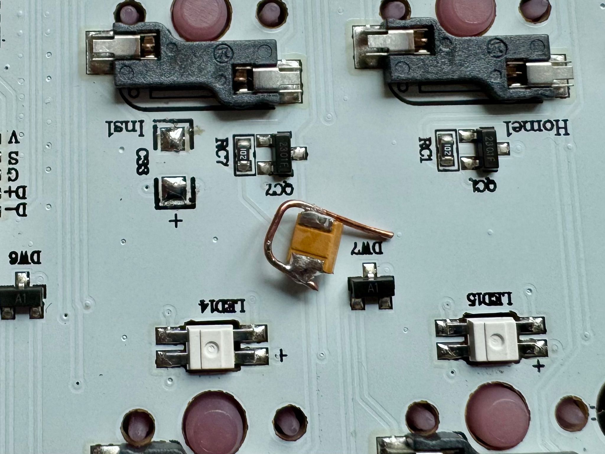 Closeup of the keyboard PCB with an orange capacitor removed