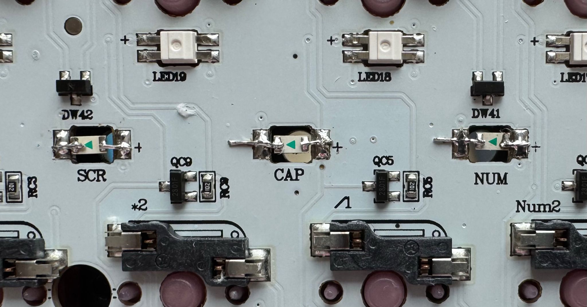 Closeup of the keyboard PCB showing that the original indicator LEDs have been replaced by smaller, white LEDs