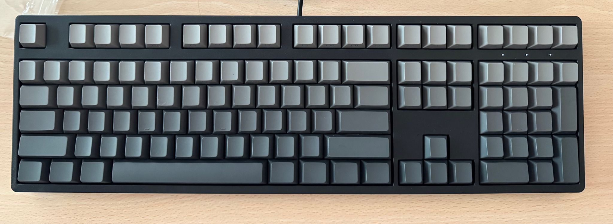 Yinren R108 keyboard plan view, black chassis, gray key switches, white indicator leds.